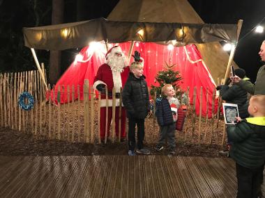 Children and Their Families Enjoying BeWilderwood Present Christmas