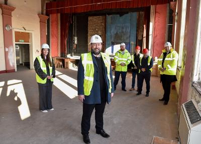 Leader of St Helens Borough Council, Cllr Anthony Burns in front with the team from HH Smith & Sons and Deputy council leader Cllr Seve Gomez-Aspron and Cllr Richard McCauley, Cabinet member for Inclusive Growth and Regeneration