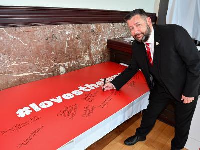 Council Leader Councillor Anthony Burns signs the #LoveStHelens board