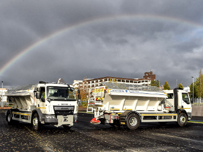 A picture of gritters under a rainbow