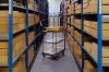 A photograph of a trolley next to shelving in a store room