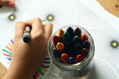 Child hand holding crayon